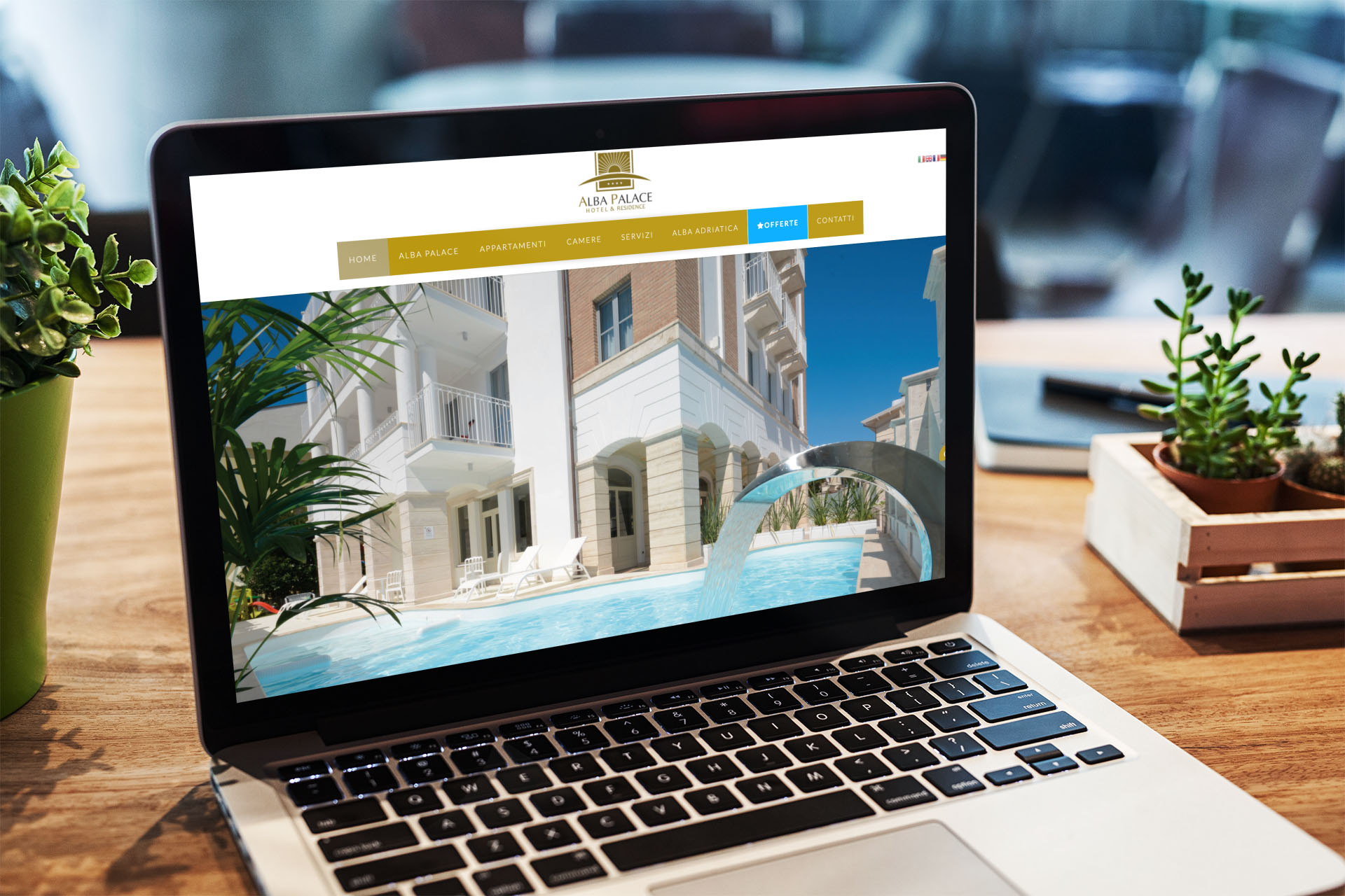Laptop sulla scrivania con Home Page responsive multi device del sito web di Alba Palace di Alba Adriatica