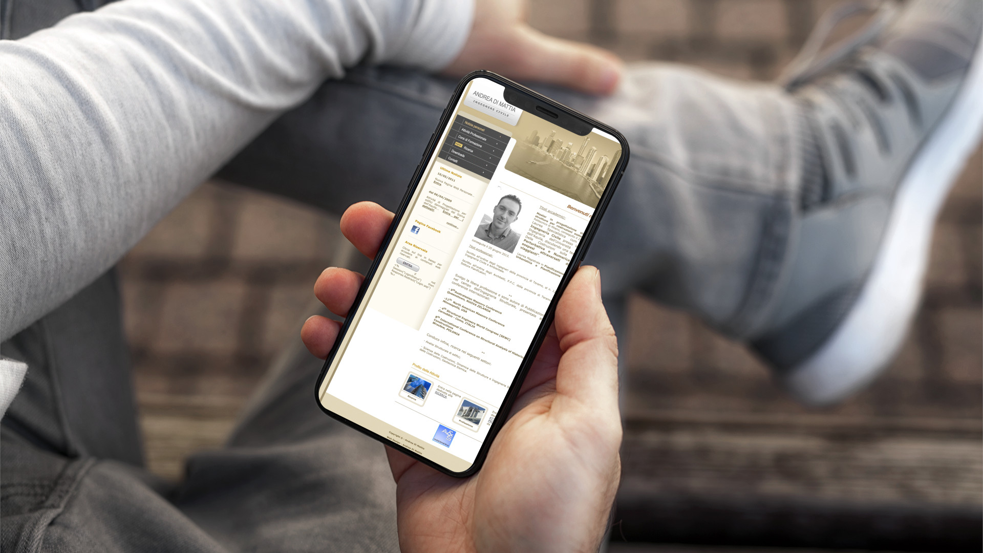 Mano con iPhone che mostra il sito web in modalità mobile di Andrea Di Mattia