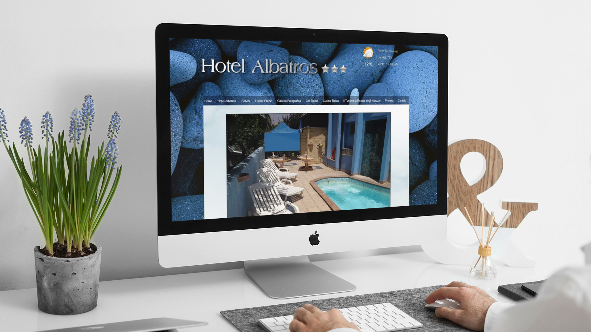 Uomo che guarda sull'iMac la home page del sito web dell'Hotel Albatros di Roseto degli Abruzzi