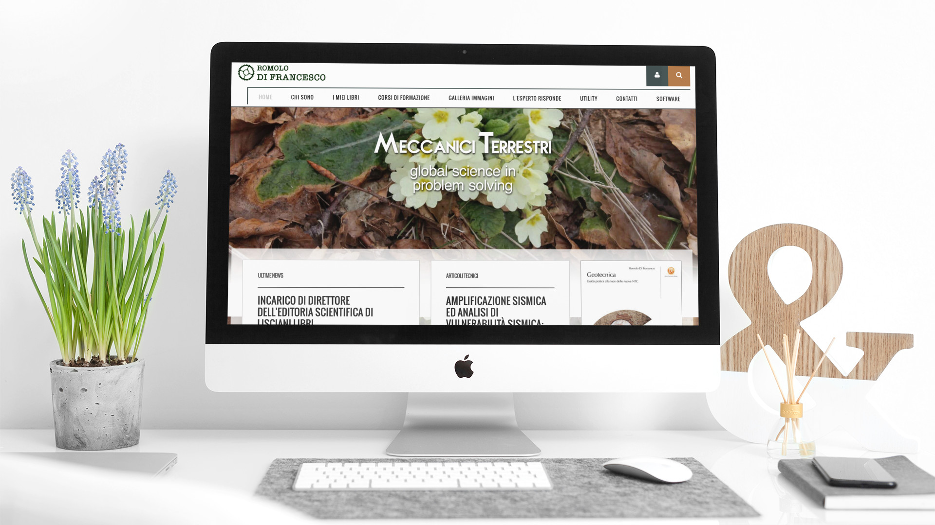 IMac sul tavolo della scrivania di che mostra la home page del sito web di Romolo Di Francesco geologo Teramo