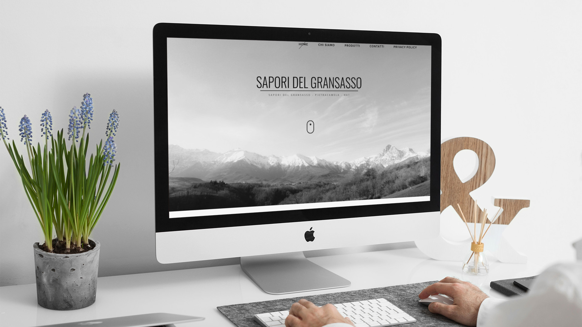 Uomo che guarda sull'iMac la home page del sito web di Sapori Del Gran Sasso di Teramo