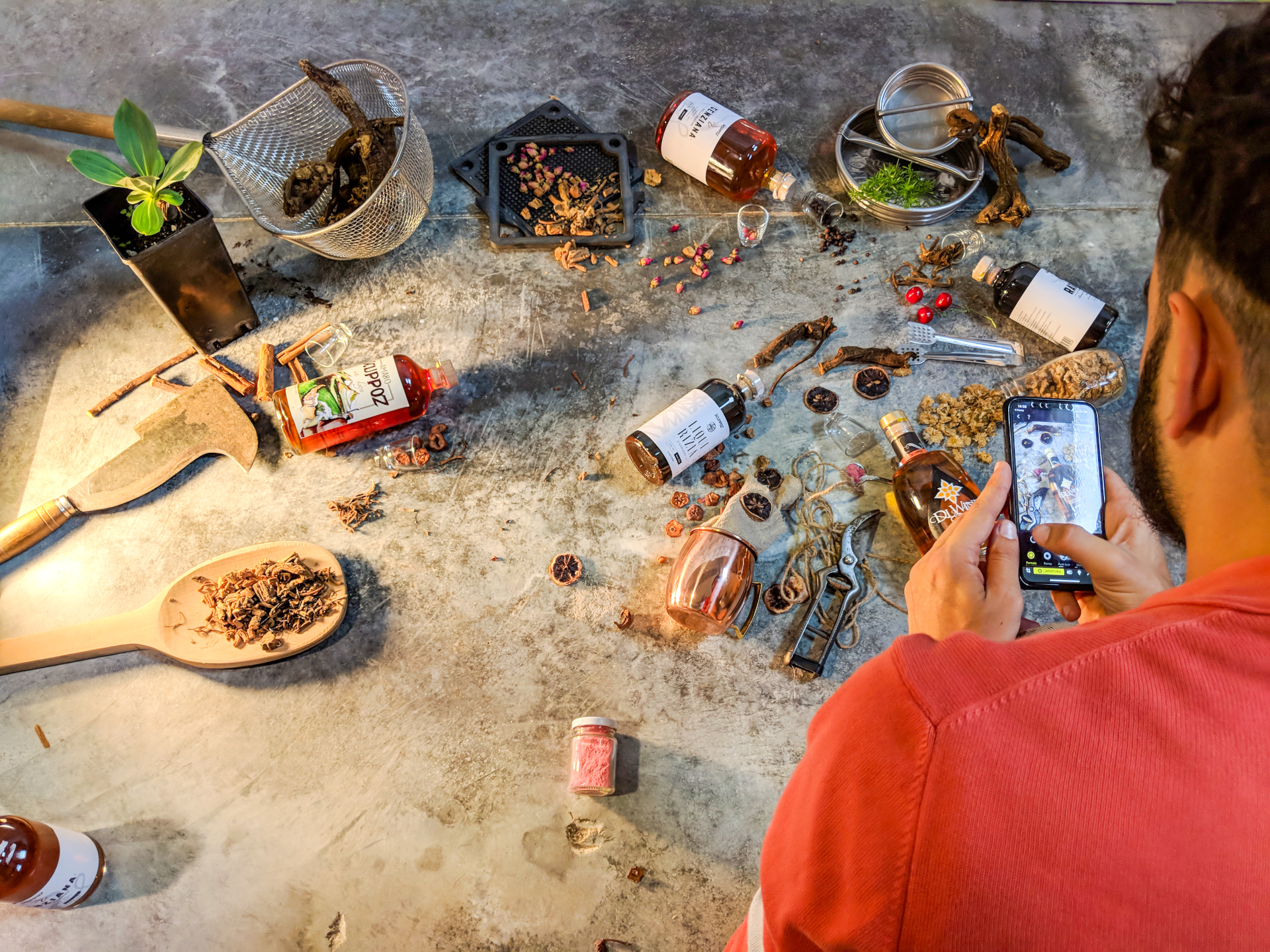 Fotografo mentre sta scattando una foto con i prodotti di Scuppoz di Teramo Abruzzo a terra sul pavimento still life