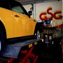 Automobile gialla sollevata sul ponte per un intervento alle ruote