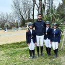 Tre giovani allieve con coccarde insieme al loro istruttore