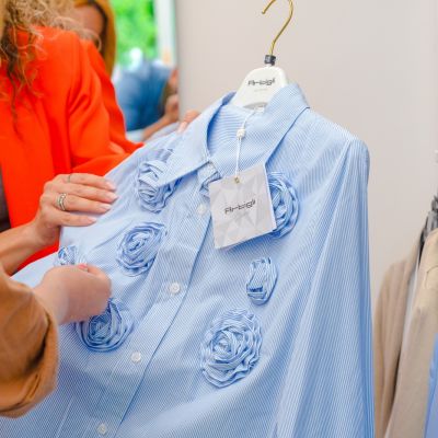 Camicia azzurra ricamata mostrata da due donne