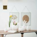 Consolle bianca con ceramiche, fiori e stampe minimaliste