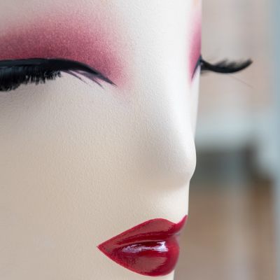 Profilo di un manichino con ciglia lunghe e labbra rosse